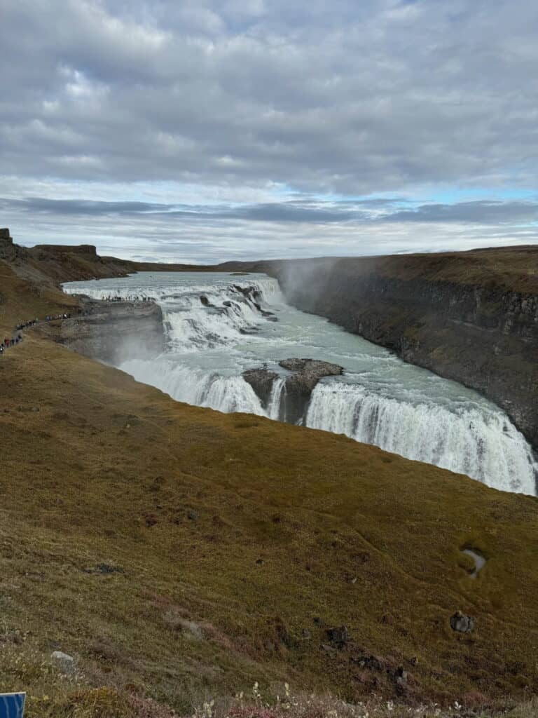 A powerful waterfall cascades over multiple tiers