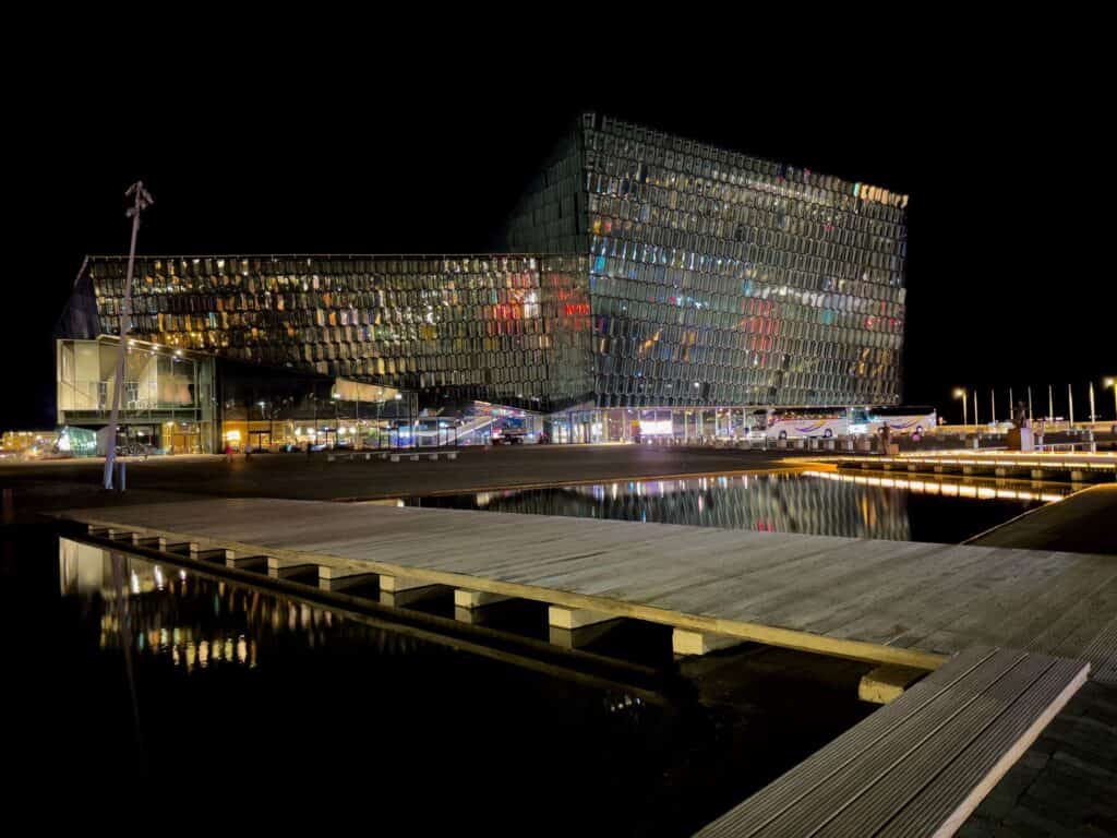 Futuristic glass building illuminated at night