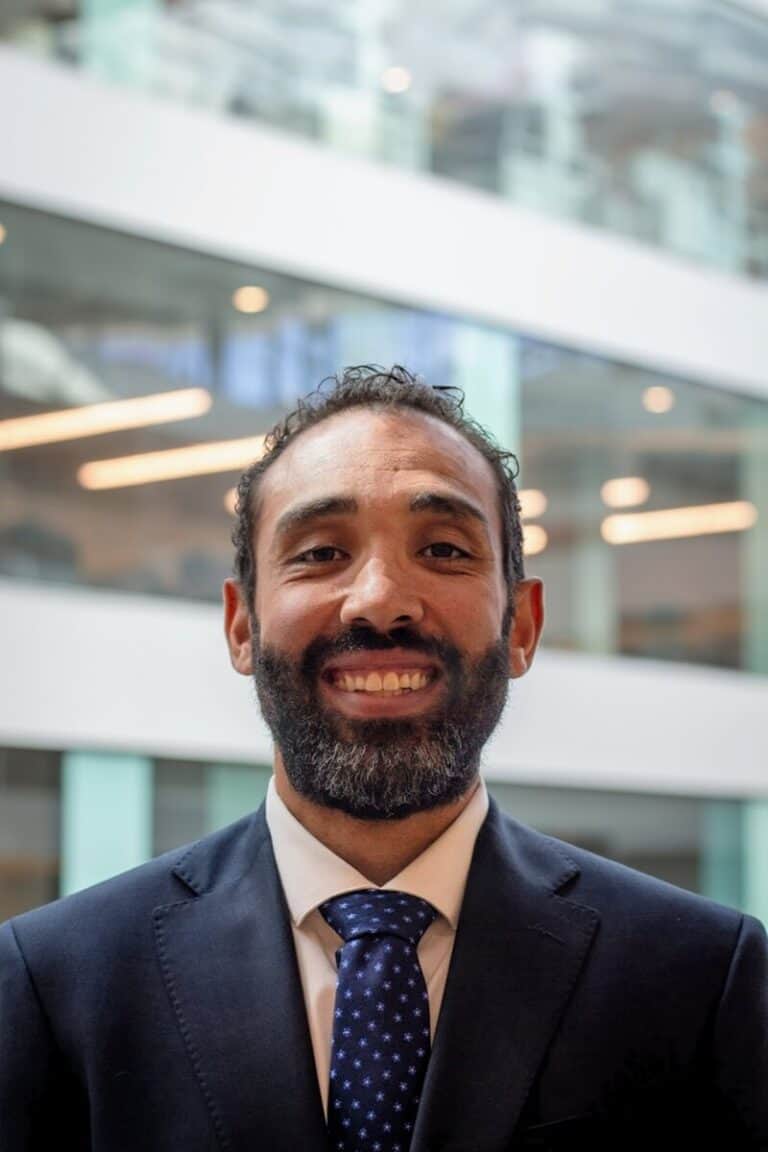 Professional man in suit smiling at the camera at University of Colorado.